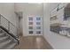 Bright foyer area with staircase, white walls, and modern art at 30 Hilltop Crest St, Henderson, NV 89011