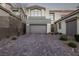 Charming home with a two-car garage and brick driveway at 30 Hilltop Crest St, Henderson, NV 89011