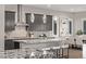 Kitchen island featuring granite countertops, pendant lighting, and shaker style cabinets at 30 Hilltop Crest St, Henderson, NV 89011