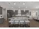 Modern kitchen with stainless steel appliances, a large granite island, and stylish pendant lighting at 30 Hilltop Crest St, Henderson, NV 89011