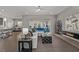 Open-concept living room features a modern fireplace and views of the pool area through sliding glass doors at 30 Hilltop Crest St, Henderson, NV 89011
