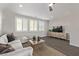 Cozy living room with modern decor, a comfortable couch, and a large window at 30 Hilltop Crest St, Henderson, NV 89011