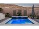 Backyard pool with a water feature and desert landscaping at 30 Hilltop Crest St, Henderson, NV 89011