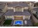 Rear exterior view of home, showcasing a private backyard with a pool, patio, and outdoor grill at 30 Hilltop Crest St, Henderson, NV 89011