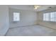 Bright bedroom featuring two windows and a ceiling fan at 3107 Lenoir St, Las Vegas, NV 89135
