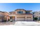 Two-story house with three-car garage and desert landscaping at 3107 Lenoir St, Las Vegas, NV 89135
