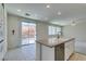 Kitchen boasts island, stainless steel dishwasher, and sliding door to patio at 3107 Lenoir St, Las Vegas, NV 89135