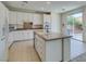 Bright kitchen with island, stainless steel appliances, and access to backyard at 3107 Lenoir St, Las Vegas, NV 89135