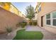 Landscaped backyard with patio, artificial turf, and gravel at 368 Gracious Way, Henderson, NV 89011