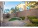 Private backyard featuring a custom stone patio, low-maintenance landscaping, and brick wall at 368 Gracious Way, Henderson, NV 89011