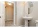 Simple bathroom with pedestal sink and oval mirror at 368 Gracious Way, Henderson, NV 89011