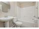 Clean bathroom with tub, toilet, pedestal sink, and mirror at 368 Gracious Way, Henderson, NV 89011