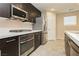 Kitchen features stainless steel appliances and dark cabinetry at 368 Gracious Way, Henderson, NV 89011