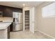 Modern kitchen featuring stainless steel appliances and a pantry for ample storage space at 368 Gracious Way, Henderson, NV 89011