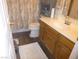 Clean bathroom with wood vanity, updated flooring, and shower/tub combo at 3940 Edgemoor Way, Las Vegas, NV 89121