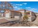 Single-story house with attached garage and desert landscaping at 402 Dune Ridge Ave, North Las Vegas, NV 89031