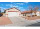 House exterior featuring a two-car garage and front yard at 402 Dune Ridge Ave, North Las Vegas, NV 89031