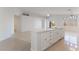 Open concept kitchen with white island and tile flooring at 402 Dune Ridge Ave, North Las Vegas, NV 89031