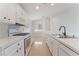 Modern kitchen with white cabinets, quartz countertops, and new appliances at 402 Dune Ridge Ave, North Las Vegas, NV 89031