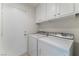 Laundry room with washer, dryer, and cabinets at 402 Dune Ridge Ave, North Las Vegas, NV 89031