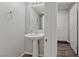 Simple bathroom with pedestal sink and gray walls at 4710 Frasers Owl Ave # 102, North Las Vegas, NV 89084