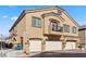 Tan two-story house with three-car garage and balcony at 4710 Frasers Owl Ave # 102, North Las Vegas, NV 89084