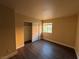 Bright bedroom with dark laminate floors and a large closet at 4965 Indian River Dr # 103, Las Vegas, NV 89103