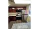 Modern kitchen with stainless steel appliances and dark wood cabinets at 4965 Indian River Dr # 103, Las Vegas, NV 89103