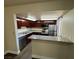 Kitchen with dark wood cabinets, granite countertops, and stainless steel appliances at 4965 Indian River Dr # 103, Las Vegas, NV 89103