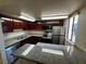 Kitchen with dark wood cabinets, granite countertops, and stainless steel appliances at 4965 Indian River Dr # 103, Las Vegas, NV 89103