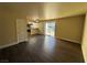 Living room with dark laminate floors and sliding glass doors to patio at 4965 Indian River Dr # 103, Las Vegas, NV 89103
