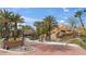 Highland Falls community entrance with waterfall feature and palm trees at 497 Fairways Dr, Mesquite, NV 89027