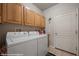 Laundry room with washer, dryer, and upper cabinets at 497 Fairways Dr, Mesquite, NV 89027