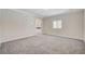 Spacious bedroom with grey carpet, an ensuite bathroom, and a walk-in closet at 5500 Santovito St, Pahrump, NV 89061