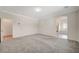 Bright bedroom with grey carpet and access to a bathroom and a walk-in closet at 5500 Santovito St, Pahrump, NV 89061