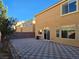 Private backyard with checkerboard patio and wall at 6538 Creekside Cellars Ct, Las Vegas, NV 89139
