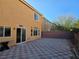 Private backyard with checkerboard patio and wall at 6538 Creekside Cellars Ct, Las Vegas, NV 89139