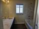 Bathroom with double vanity, bathtub, and window at 6538 Creekside Cellars Ct, Las Vegas, NV 89139