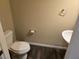 Small bathroom with white toilet and pedestal sink at 6538 Creekside Cellars Ct, Las Vegas, NV 89139