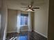 Bedroom with hardwood floors, large window, and ceiling fan at 6538 Creekside Cellars Ct, Las Vegas, NV 89139