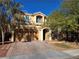 Two-story house with a three-car garage and landscaped yard at 6538 Creekside Cellars Ct, Las Vegas, NV 89139