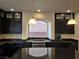 Spacious kitchen boasts dark cabinetry, granite countertops, and an island at 6538 Creekside Cellars Ct, Las Vegas, NV 89139
