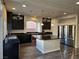 Modern kitchen with dark cabinets and granite countertops at 6538 Creekside Cellars Ct, Las Vegas, NV 89139