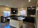 Modern kitchen with dark cabinets and granite countertops at 6538 Creekside Cellars Ct, Las Vegas, NV 89139