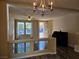 Open living room with hardwood floors and a chandelier at 6538 Creekside Cellars Ct, Las Vegas, NV 89139