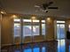 Living room with hardwood floors, large windows, and ceiling fan at 6538 Creekside Cellars Ct, Las Vegas, NV 89139