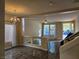 Open living room with hardwood floors and a chandelier at 6538 Creekside Cellars Ct, Las Vegas, NV 89139