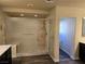 Walk-in shower with glass enclosure and marble-look tile at 6538 Creekside Cellars Ct, Las Vegas, NV 89139