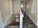 Upstairs hallway with wood-look floors and access to bedrooms at 6538 Creekside Cellars Ct, Las Vegas, NV 89139