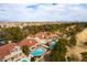 Stunning aerial view captures the community's lush landscaping, pools, and views of the Las Vegas skyline at 7909 Rio Rico Dr, Las Vegas, NV 89113